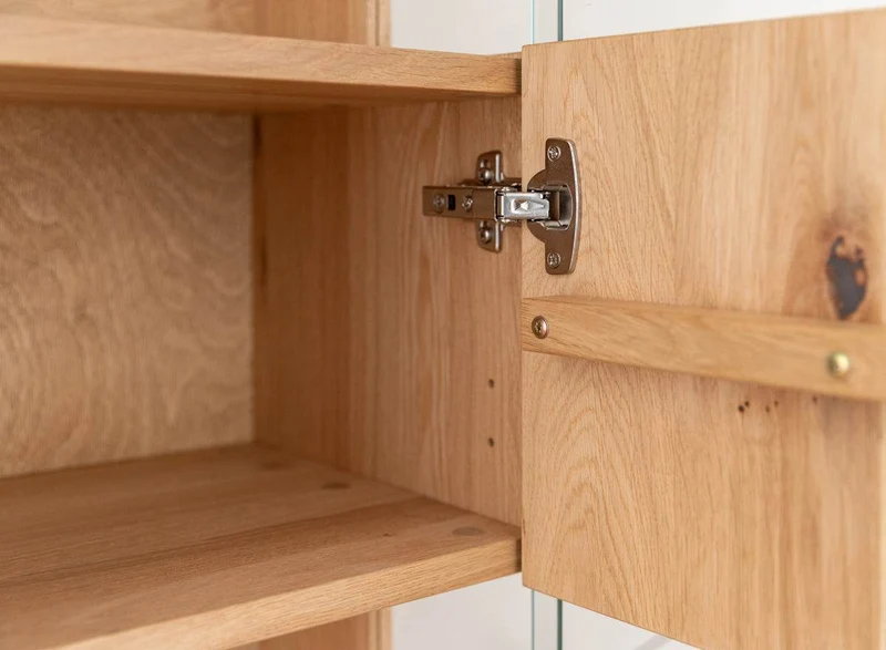 Beleuchtete Hängevitrine aus massiver Eiche mit Lamellen | Vitrine Tirano II mit Rückwand in grober Holzstruktur