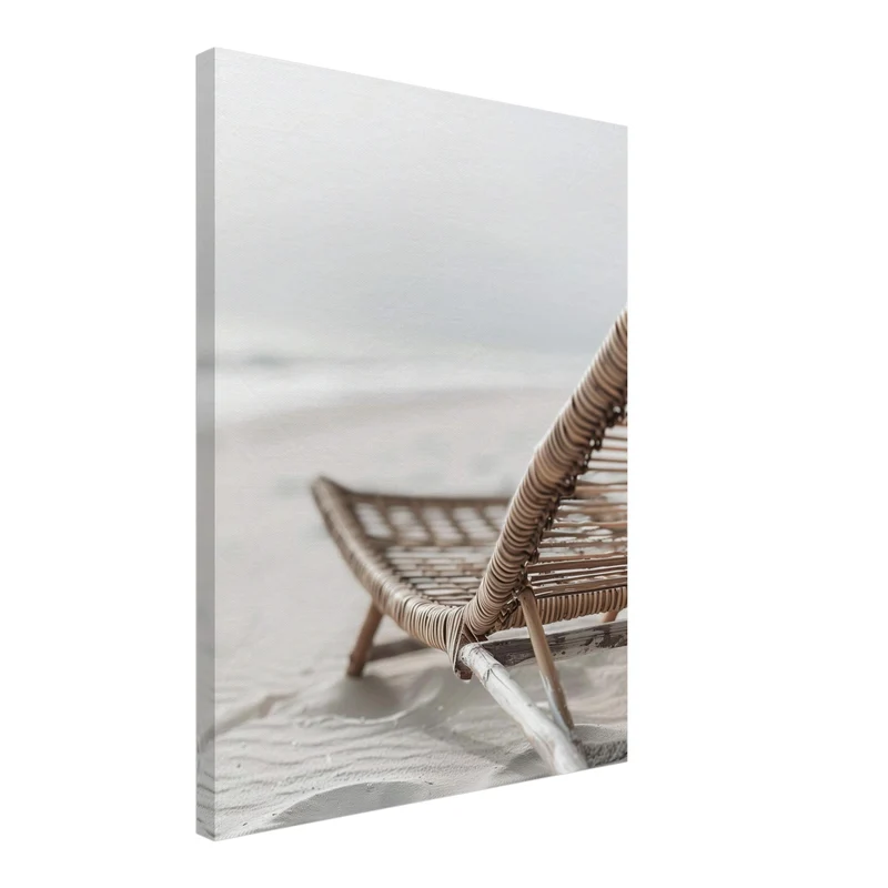 Geflochtener Strandstuhl im Sand Leinwandbild